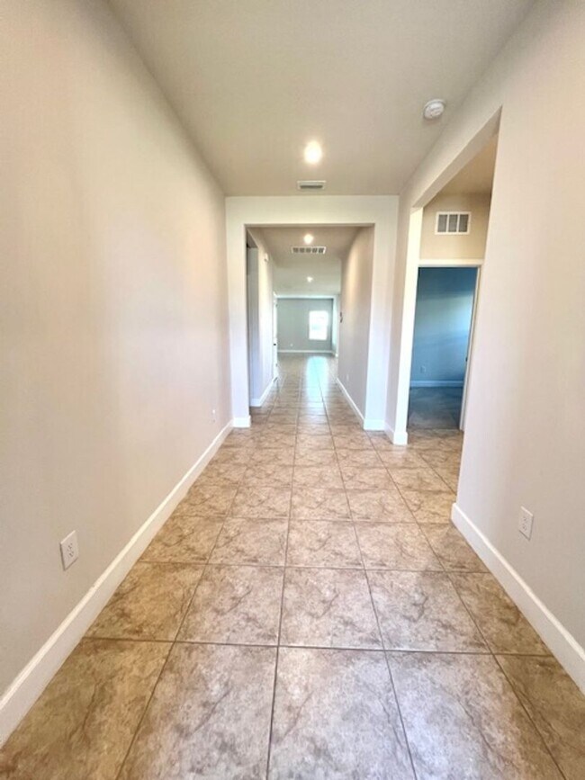 Building Photo - Open concept home offering four bedrooms, three baths, a two car garage and open lanai.