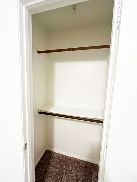 The in room closet has 2 poles and 1 rack for storage. - 4917 Jamesway Rd