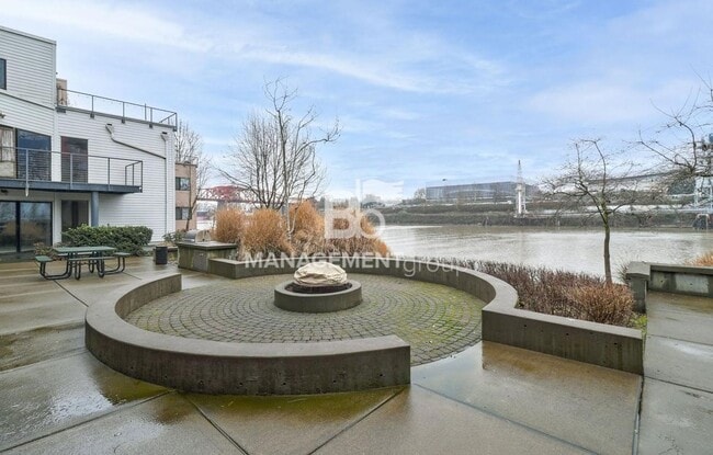 Building Photo - Spacious Riverfront Condo- Beautiful Condo w/River View from Bedroom! Parking Included!