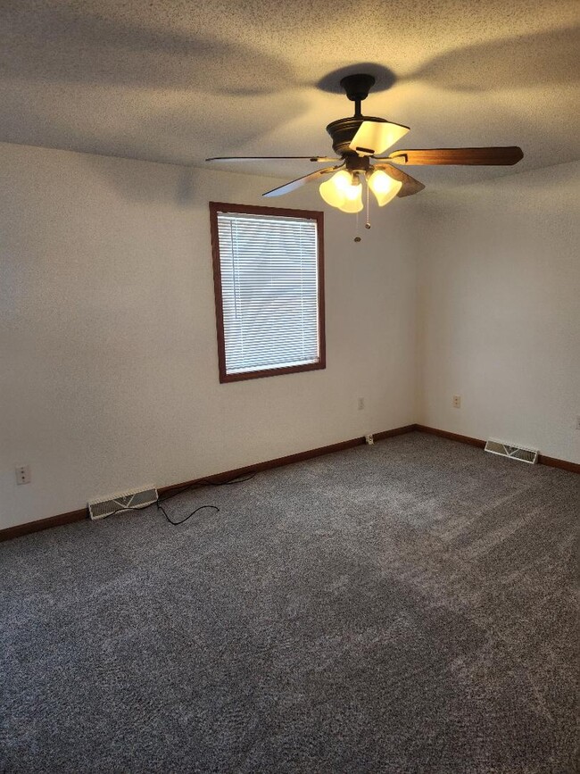 Master bedroom with new carpeting and window blinds. - 6568 Ward Rd