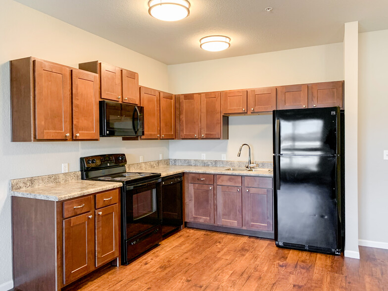 Kitchens with Plank Flooring & Black Appliances - The Residence at Yukon Hills