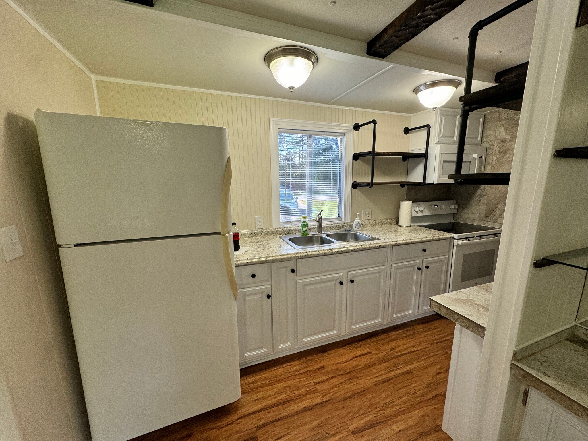 Galley kitchen with new cabinets and shelving. - 1768 Pitch Landing Rd