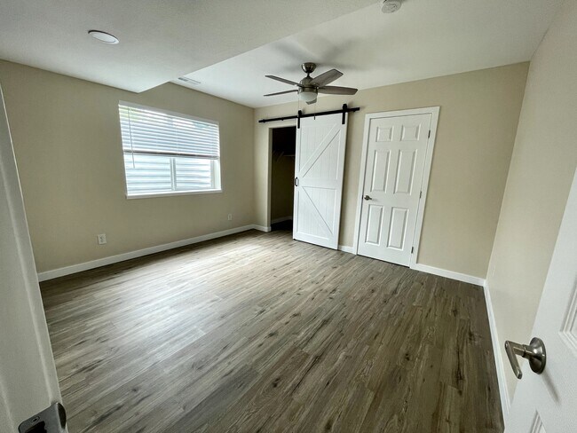 Main room with ceiling fan and walk in closet - 12838 Arezzo Cir