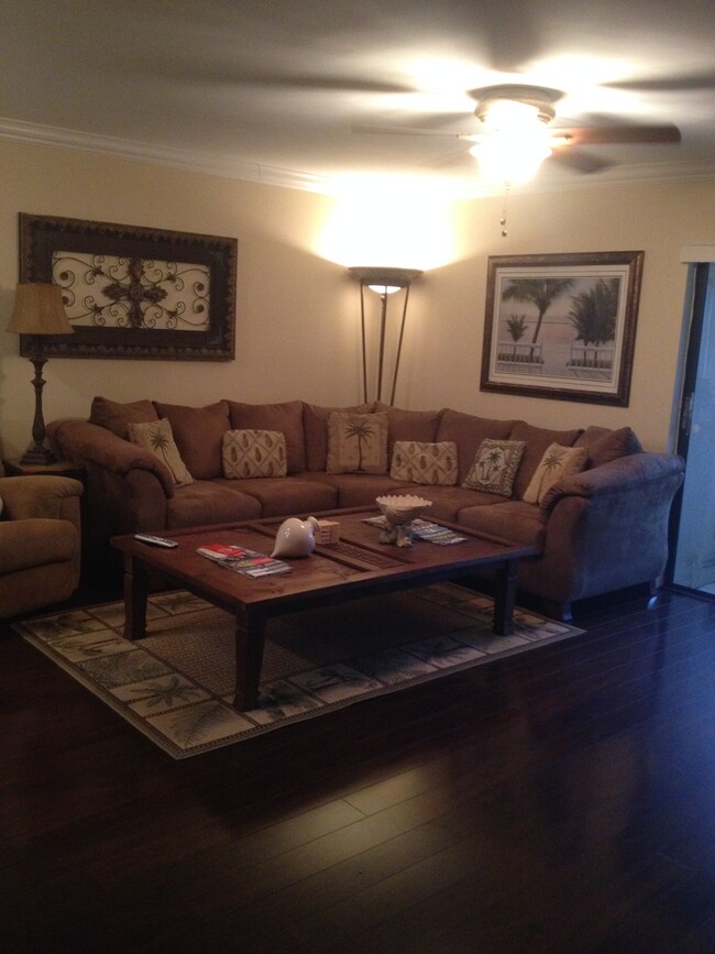 living room with large sectional and rocker - 135 Deer Creek Blvd