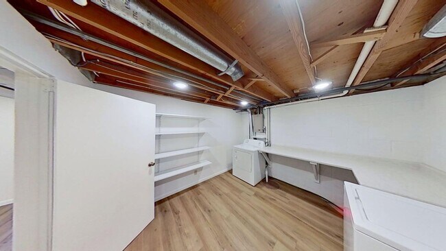 Building Photo - Updated two bedroom duplex, new stainless steel appliances, garage, and hardwood floors