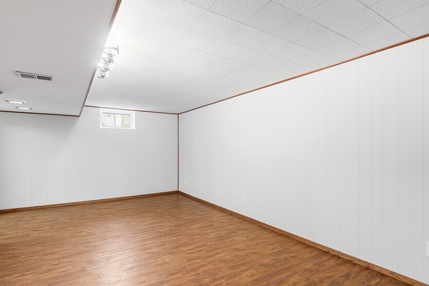 Lower-level family room w/ new lighting, paint & fixtures! - 7131 Ewing Ave N