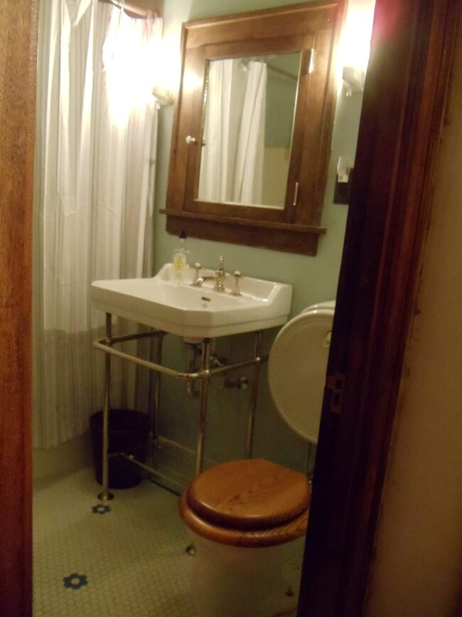 The sink and toilet look antique, but they are modern replacements. - 1407 Monroe St