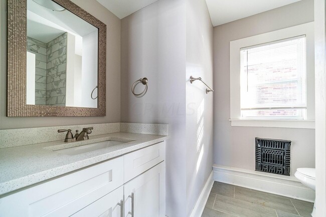 Sunny bathroom with all new fixtures. - 222 Parkwood Ave