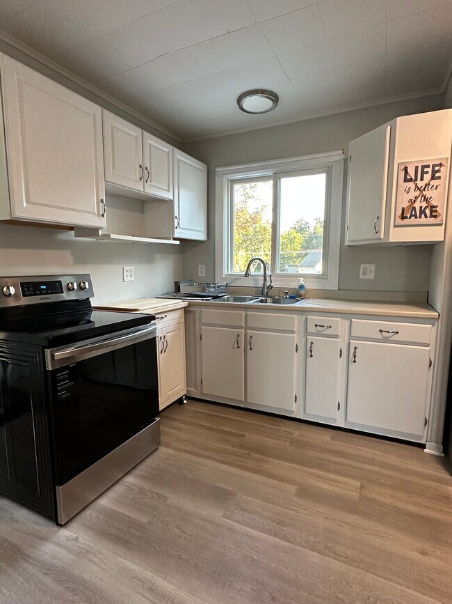 Kitchen with stove and range. - 16 Crescent Beach Dr
