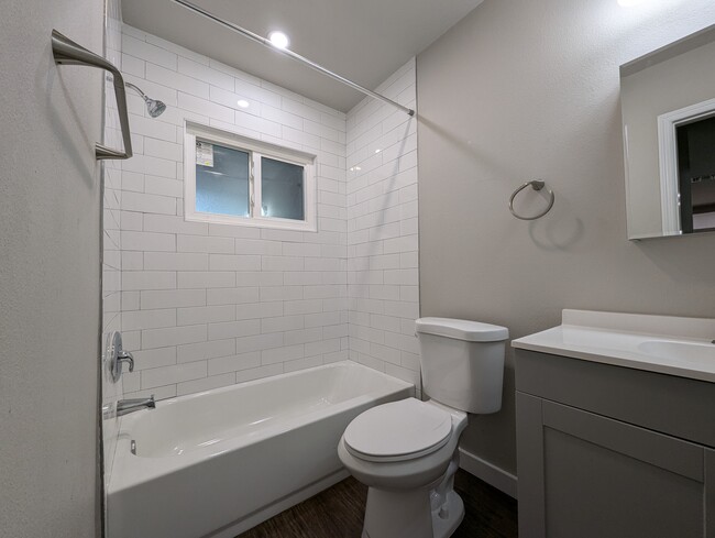 Recently renovated bathroom w/ soaking tub & privacy glass window - 1814 26th St W