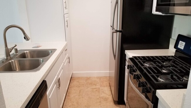 Kitchen with tile floor and appliances included - 14126 Tiara St