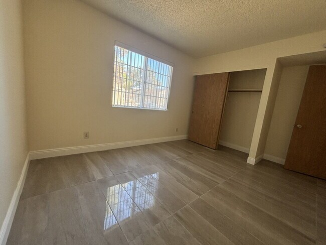 Building Photo - Downstairs 2BR/1BA—recently updated with new flooring, new countertops, and clean, neutral finishes.