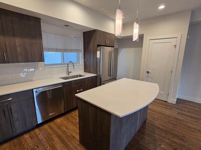 Building Photo - STUNNING 4-LEVEL TOWNHOME IN HIGHLANDS WITH SAUNA, 2-CAR GARAGE + AMAZING ROOFTOP DECK!