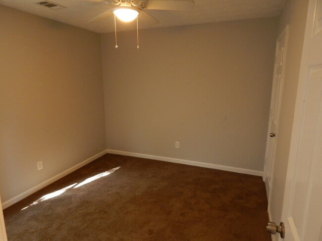 Building Photo - Freshly painted and new flooring in this 4 Bedroom 2 and Half Bath home. Covered front porch with...