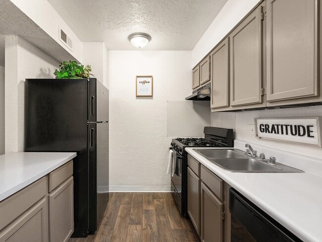 Kitchen with Hardwood Style Flooring - Mission Hill Apartments