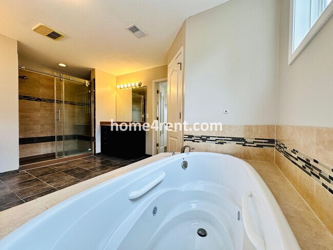 Building Photo - Beautiful Four-Bedroom Home with Three Car Garage, Wood Floors, Finished Basement and a Fenced Ya...