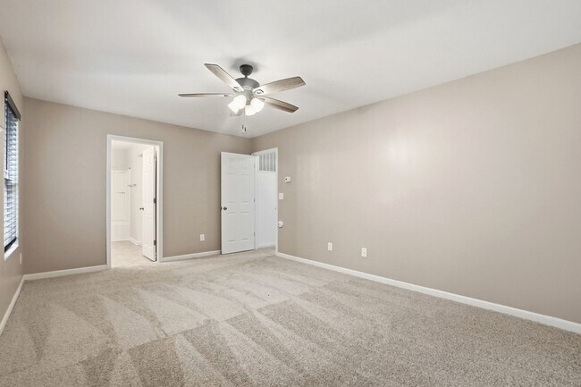 Building Photo - Spacious 4BR Home with New Carpet & Fenced Backyard