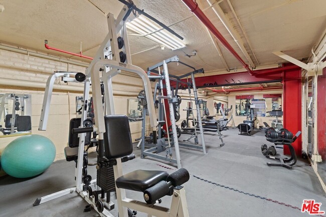 Gym includes tvs, treadmill, rowing machine, and new weight equipment. - 4125 S Figueroa St