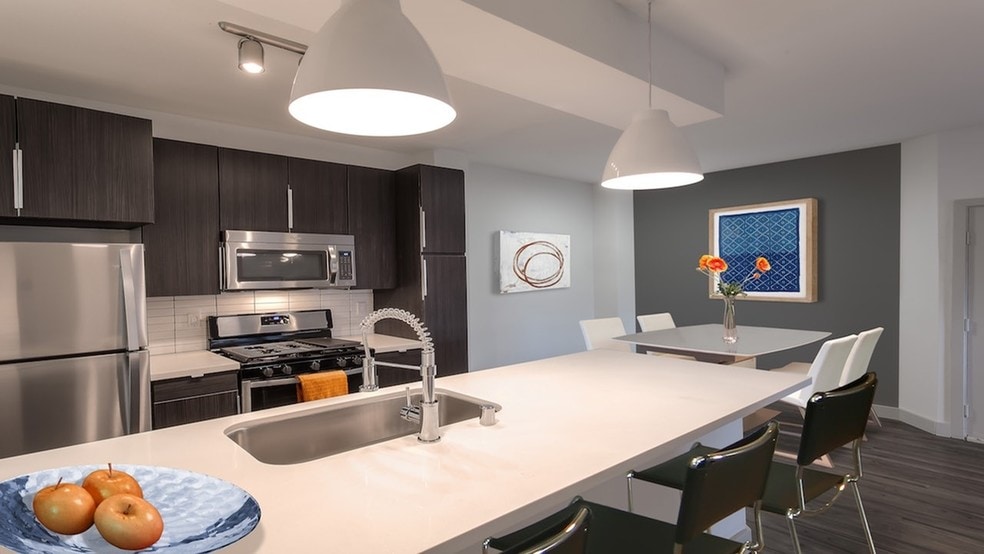 Quartz countertops, custom cabinetry and stainless steel appliances in our redesigned homes - Alister Sherman Oaks