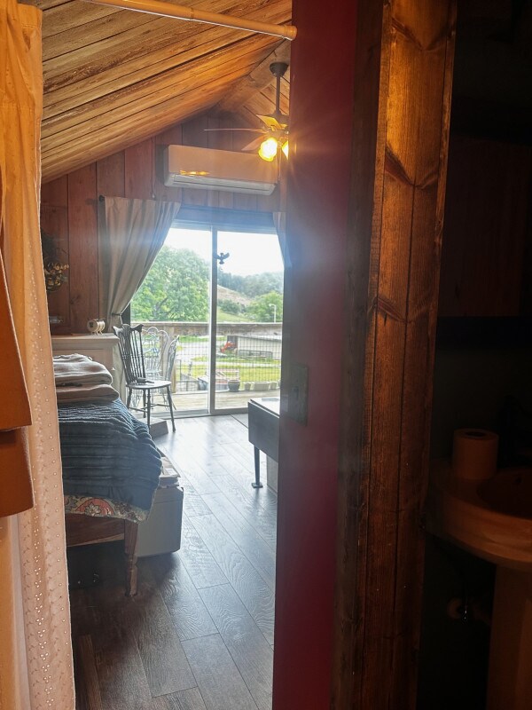view from bathroom entry out into bedroom and entry door - 1314 Rugby Rd