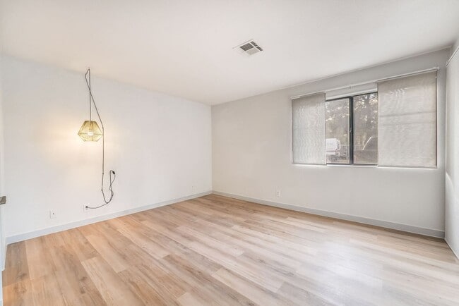 Building Photo - Upgraded Three-Bedroom Condo with Wood Flooring and Modern Comforts!
