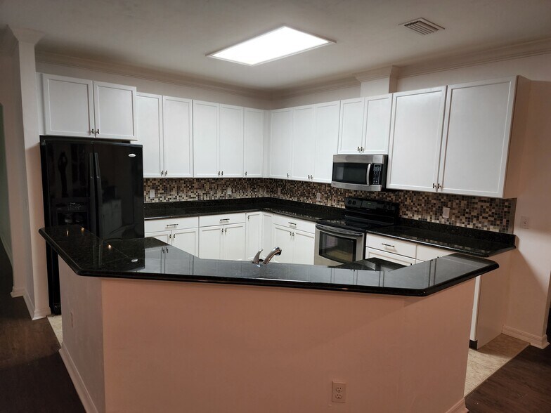 Kitchen features painted cabinets - 8184 SW 73rd Ln