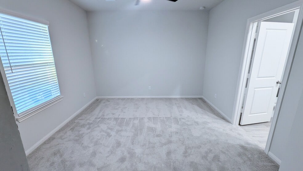 This peaceful bedroom has direct access to the en suite bathroom. - 13218 HP Johnson St