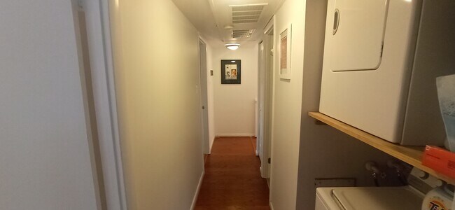 Hallway separates living areas from bedrooms - 100 Roberts Ln