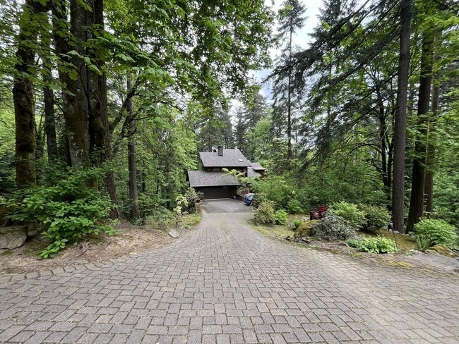 Building Photo - One-of-a-Kind Custom Home with Wall of Windows, Stone Fireplaces, Expansive Entertainment Space &...
