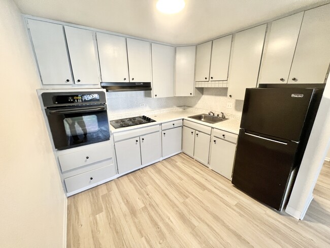 Explore this stylish and efficient kitchen, perfect for culinary adventures. - Rhapsody Apartments