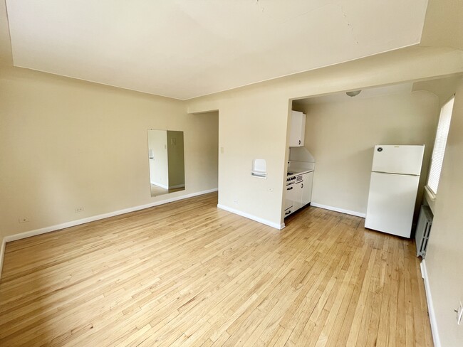 Explore this charming studio with elegant hardwood flooring and a cozy kitchen area. - Hillside Apartments