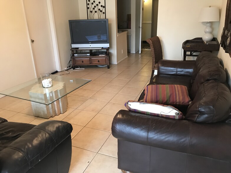 living room with matching brown leather sofa & loveseat - 480 NW 20th St