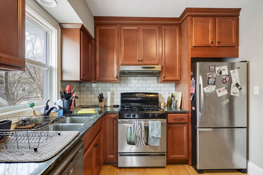 Stainless steel appliances and beautiful cherry cabinets. - 4445 Colfax Avenue South