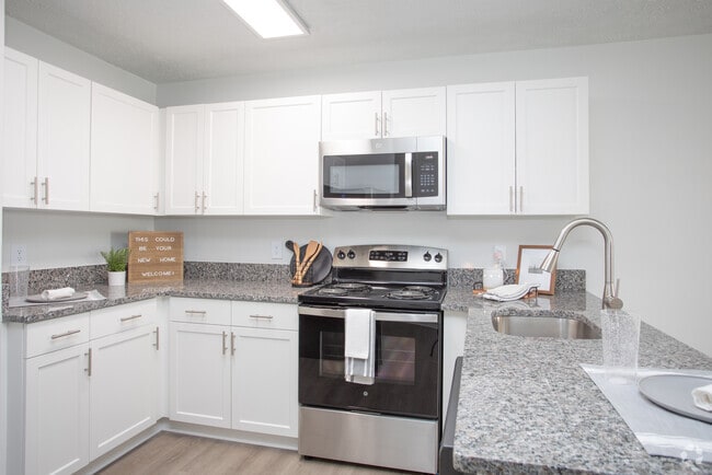 Modern Kitchen with Granite Countertops & Stainless-Steel Appliances - Timber Woods