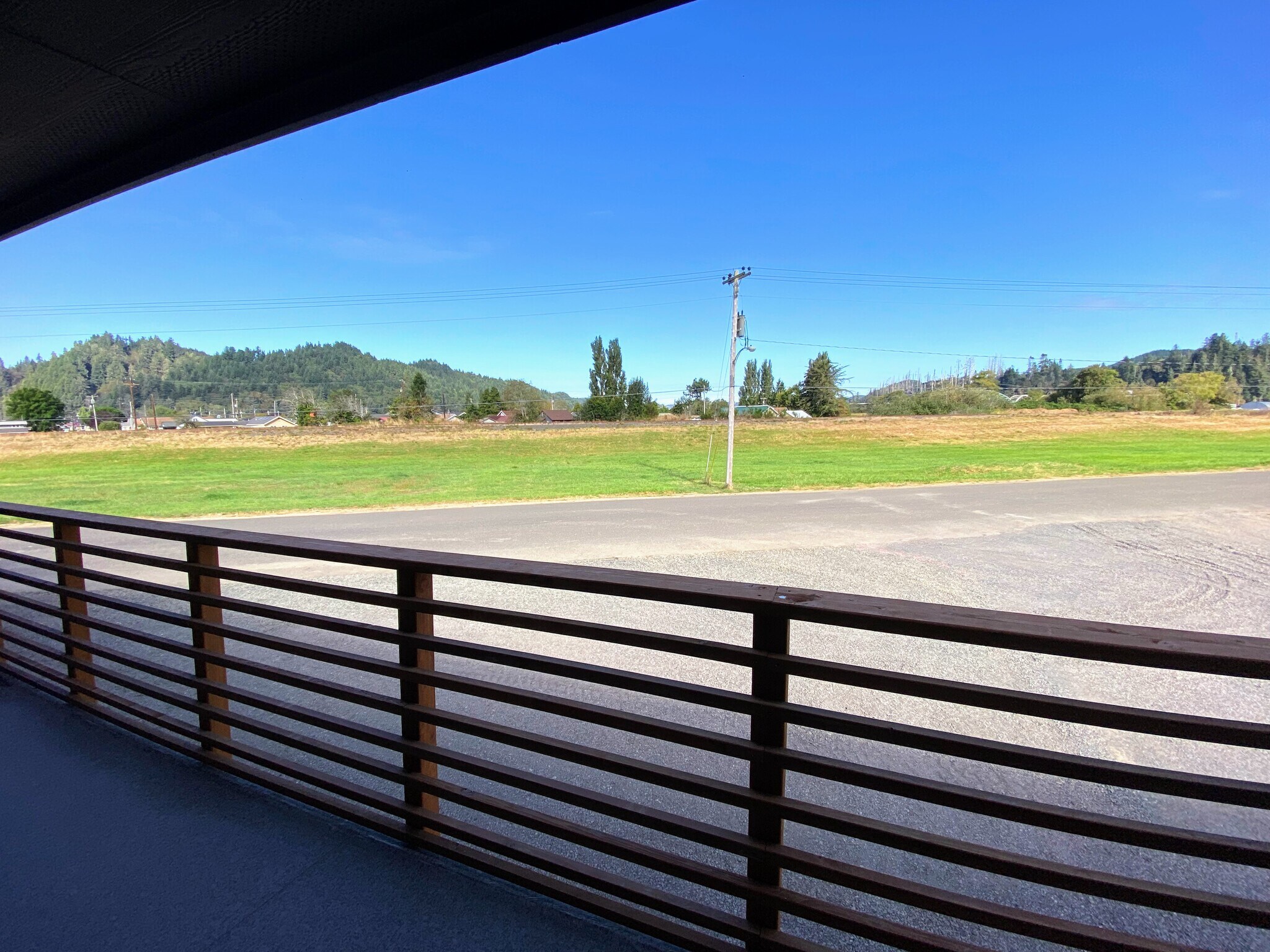 Relax on the community porch and enjoy wide open views of the field and surrounding hills. - 575 Greenwood Ave