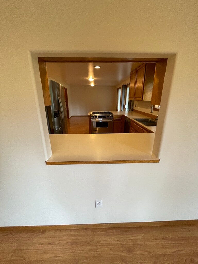 Peekaboo into kitchen from dining area - 3921 Magrath Rd