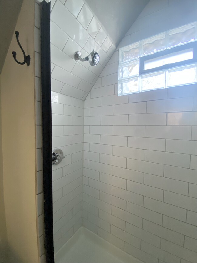 Walk-in shower with natural light. - 16 Eames St