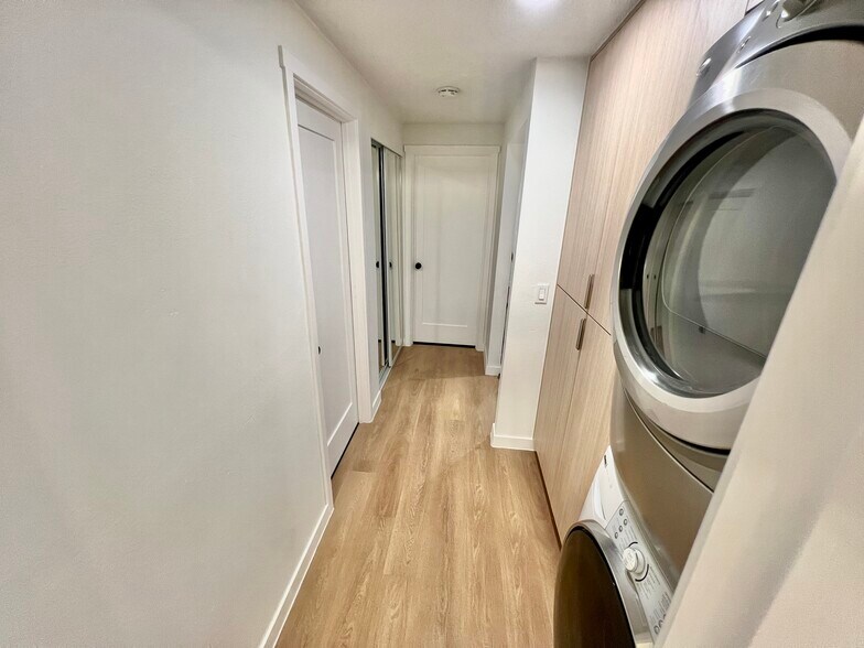 Hallway: laundry storage, washer, and dryer - 6722 S Monroe St