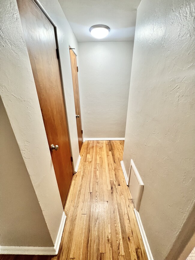 Experience the inviting elegance of this brightly lit apartment corridor. - The Birney Apartments