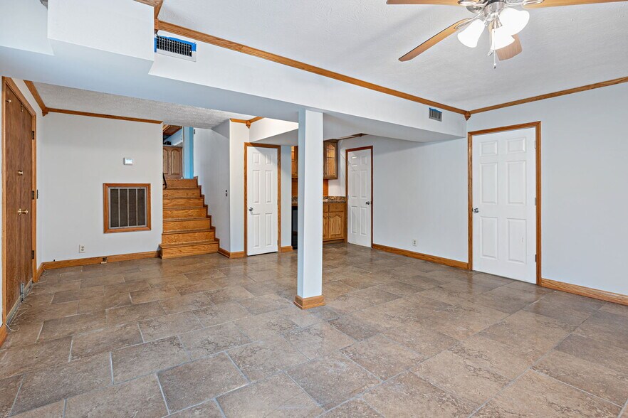 Den with stairs up to kitchen - 3841 Dubois Dr