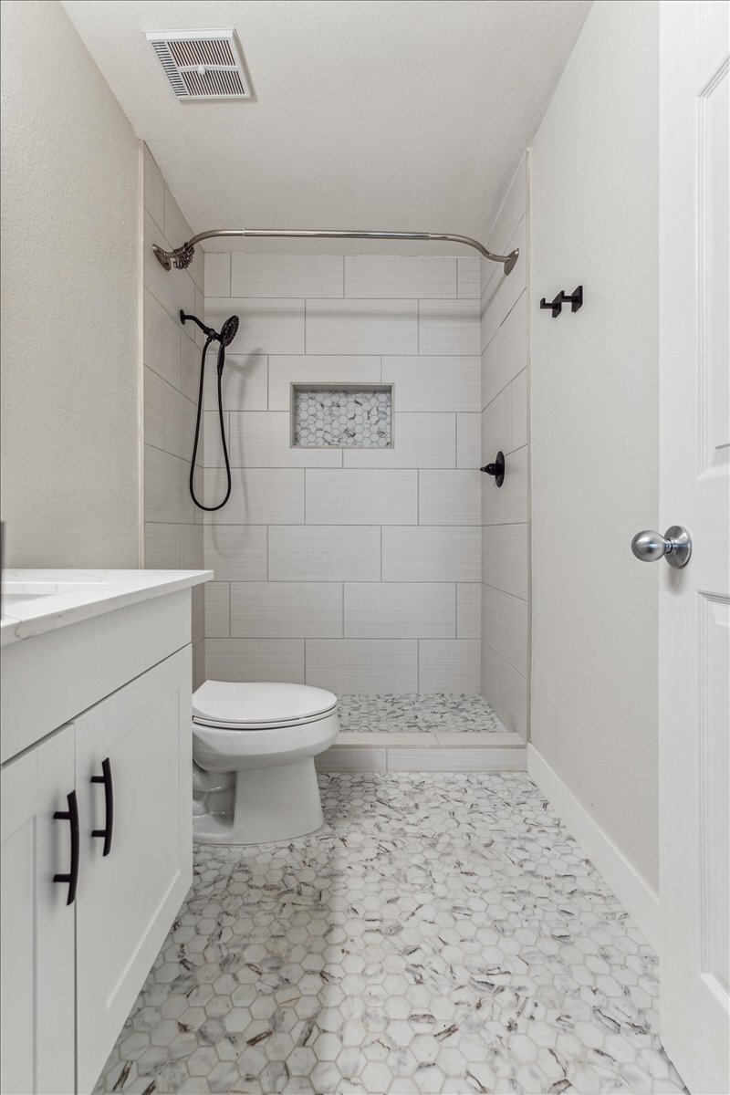 Primary shower now has glass sliders enclosure - 101 N 7th St