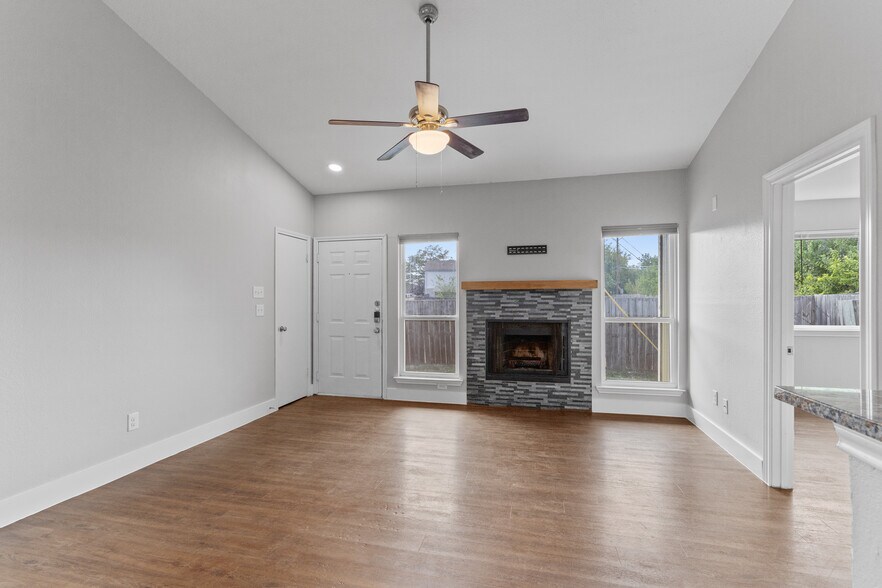 Living room. Main "side" door is to the left of fireplace. Primary bedroom is on the right. - 602 Peterson St