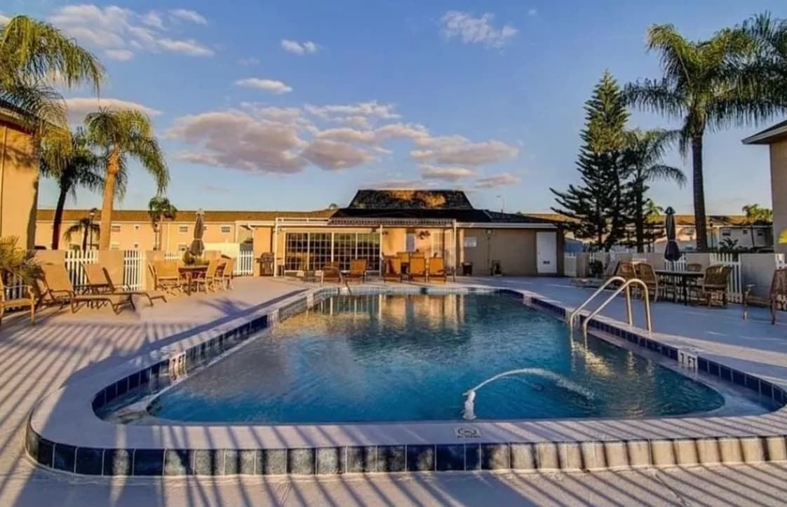 pool overlooking the water. - 8811 Bay Pointe Dr