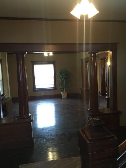 entry/foyer looking into the living room. standing at the base of the steps. all original woodwork has been preserved. - 1545 S 13th St