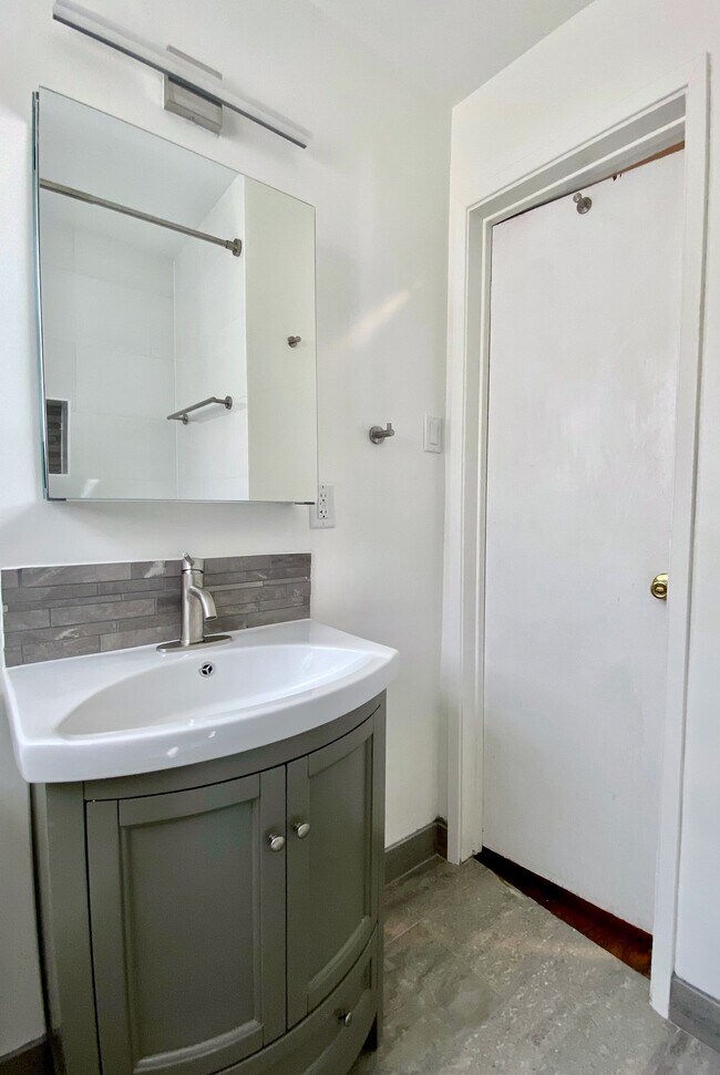 Mirrored vanity and cabinet with ample storage. - 1672 Rotary Dr