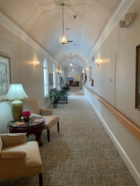 wide and well lit hall in the building - Sunabella Senior Living