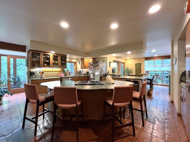 Building Photo - One-of-a-Kind Custom Home with Wall of Windows, Stone Fireplaces, Expansive Entertainment Space &...