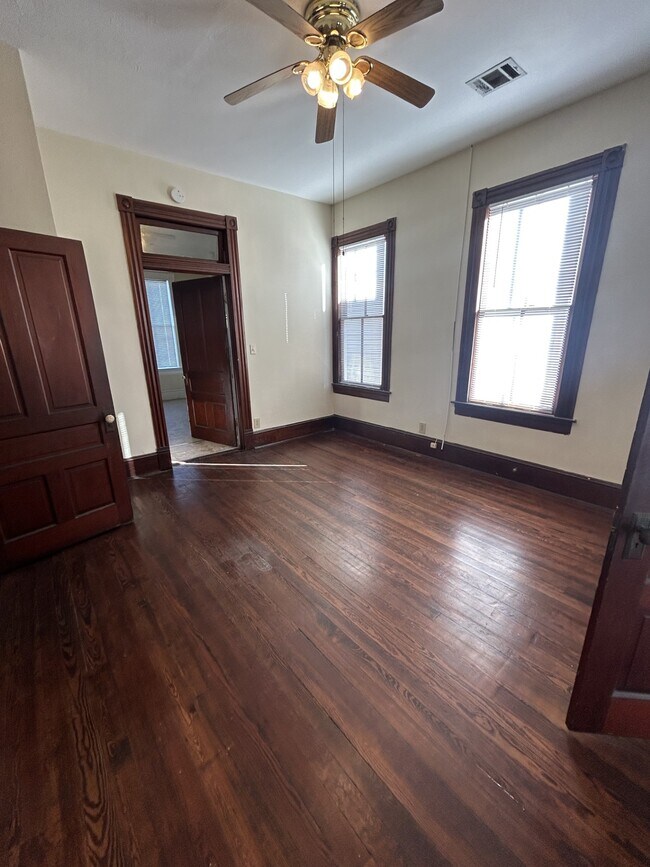 Middle bedroom with door to kitchen in the background. - 1118 25th St