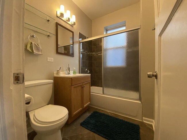 Nice bathroom with vanity storage and a glass shower enclosure - 3156 W Diversey