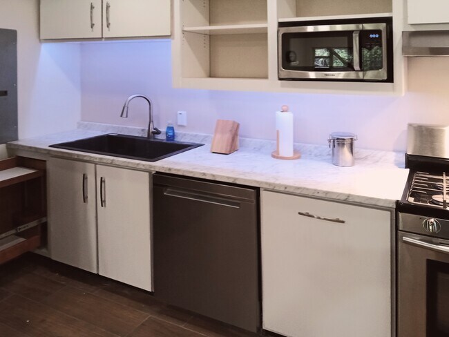 Composite granite sink and pull-out pantry. - 8008 149th St NW